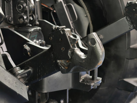 Detail of a sturdy tractor hitch showcasing robust engineering and precision mechanics in a...