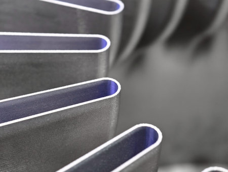 Innovative metal components produced through additive manufacturing and 3D printing technology in a modern workshop environmentの写真素材