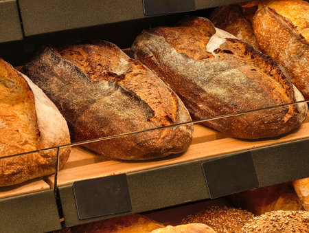 Freshly baked artisanal bread loaves displayed in a cozy bakery during a bustling morning