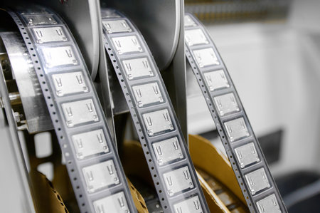 Plastic tape tape-and-reel packaging for SMT components in an industrial setting