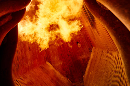 Intense flame combustion in a steam boiler furnace at a thermal power plant showcasing heat exchange surfacesの写真素材