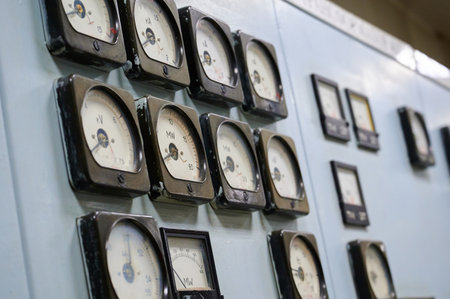 Vintage control panel with multiple gauges used for monitoring machinery in an industrial facilityの写真素材