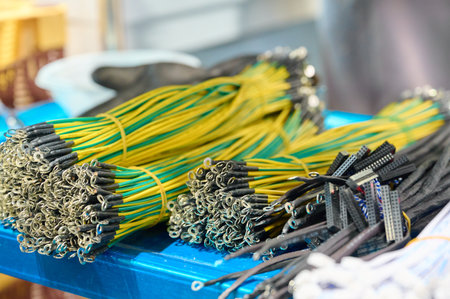 Bundles of colorful electrical wires on a blue table in a workshop for crafting and repairs during...