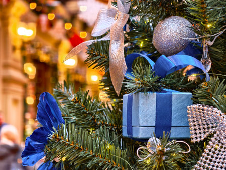 Vibrant holiday decorations adorn a beautifully wrapped Christmas tree in a festive indoor setting...