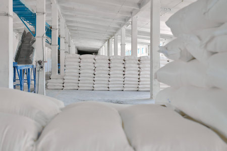 Wheat flour bags stored in an organized warehouse ready for distribution and processingの写真素材