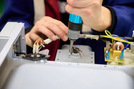 Assembly process of microwave oven electrical components on a conveyor line in a manufacturing...
