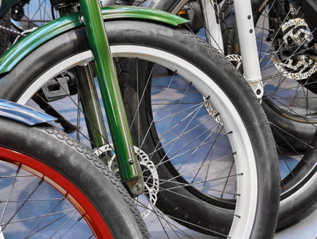 Colorful bicycle wheels displayed in a vibrant shop, showcasing unique designs and craftsmanship during a sunny afternoonの写真素材