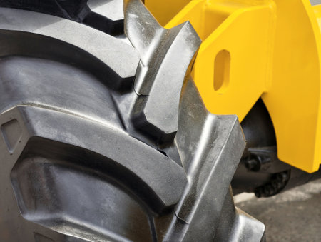 Details of construction equipment wheels showcasing robust design and tread pattern for increased...