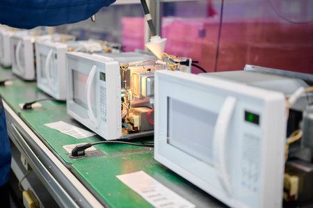 Engineer conducts microwave leakage testing on production line equipment during quality controlの写真素材