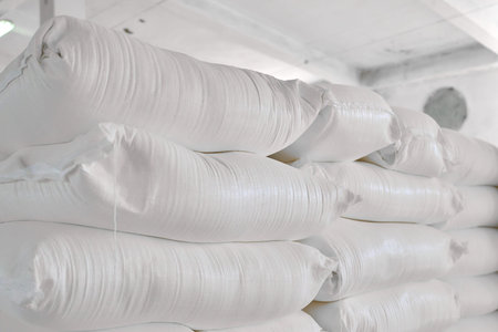 Warehouse storing sacks of wheat flour arranged neatly on shelvesの写真素材