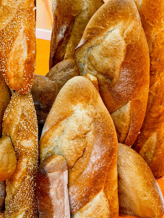 Delicious assortment of freshly baked breads arranged in a playful display at a bakery during a...