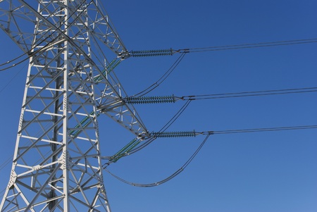 electricity pylon before blue skyの写真素材