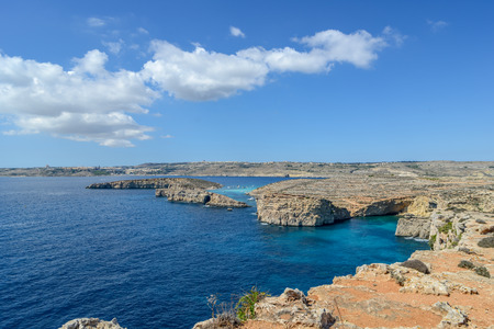 rocky cliffs of Gozo in blue sea near Maltaの写真素材