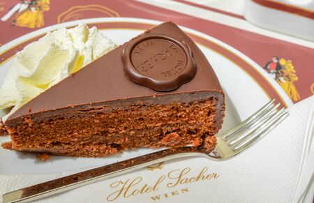 VIENNA, AUSTRIA - JUNE 01. 2016: Original Sacher Torte with cream and fork at Sacher Cafe, Vienna, Austria, Europe june 01, 2016のeditorial素材