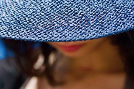 smiling girl with blue hat and red lipsの写真素材