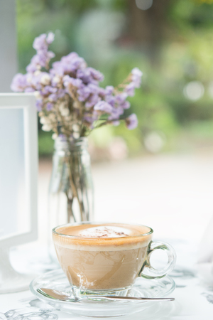 Cappuccino coffee in clear cup on table cafeの写真素材