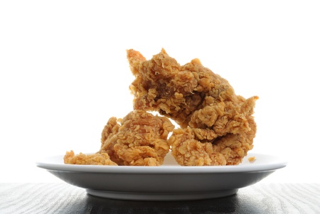 front view of fired chicken on plate with focus stacking technic isolate on white backgroundの写真素材