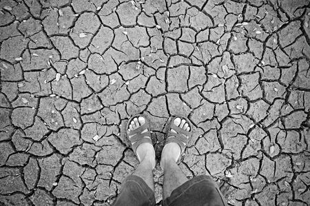 human standing on dry soil の写真素材