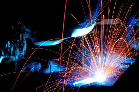 sparks while welder uses torch to weldingの写真素材
