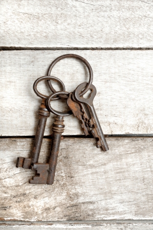 old keys with ring on wooden backgroundの写真素材