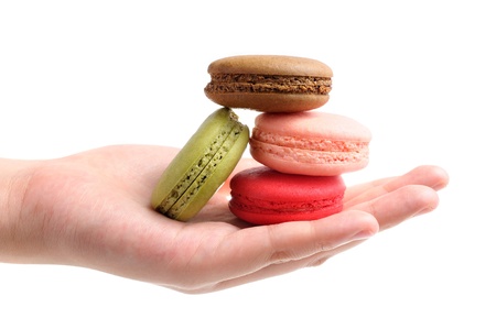 closeup colorful french macarons in handの写真素材