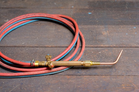closeup gas welding torch on working table