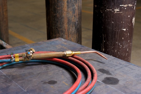 closeup gas welding torch on working table