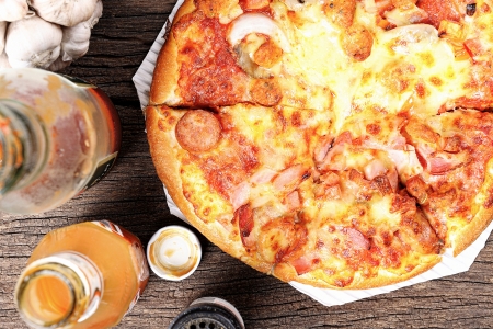 fresh hot and tasty pizza on wooden tableの写真素材