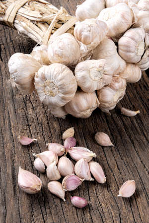 closeup garlic isolated on wooden tableの写真素材