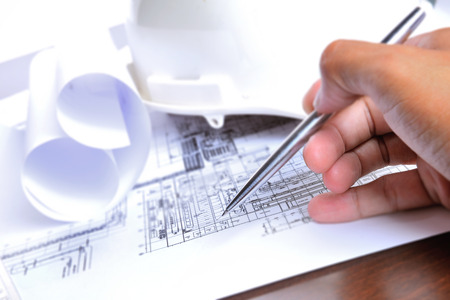 engineering plant drawing with pen in hand
