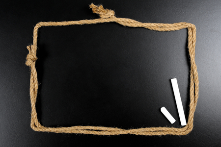 blank blackboard with rope frameの写真素材