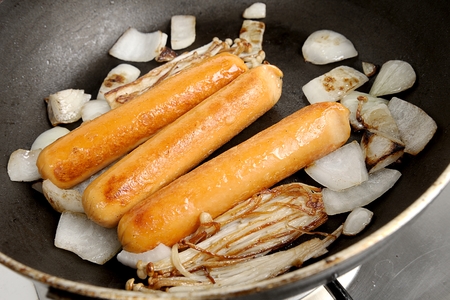 closeup fried sausage in the pan with onion and mushroomの写真素材