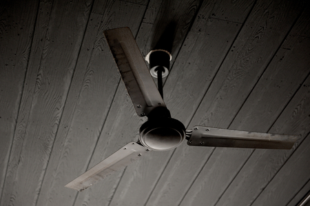 closeup old black ceiling fanの写真素材