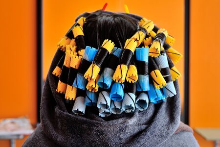 closeup colorful curlers rolling women hairの写真素材