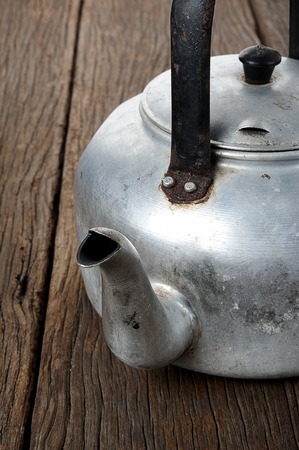 isolated old and grungy aluminium kettleの写真素材