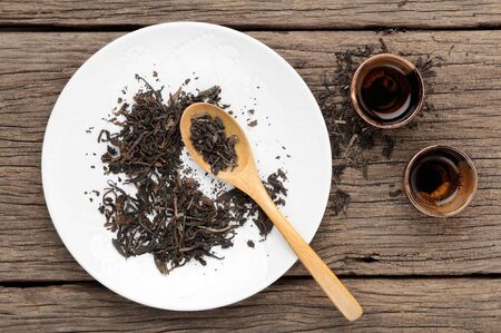 closeup tea in white plate with tea cupの写真素材