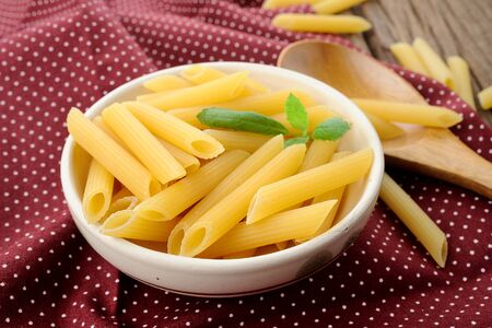 closeup dried italian pasta (penne)の写真素材