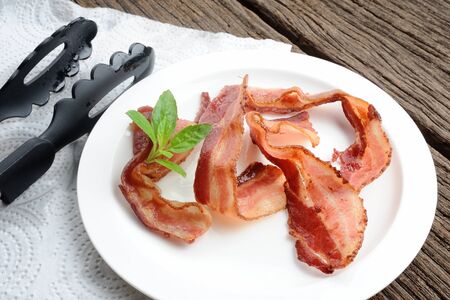 closeup fried bacon on white plateの写真素材