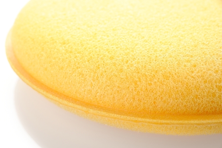 yellow double layer sponge for car waxing isolate on white backgroundの写真素材
