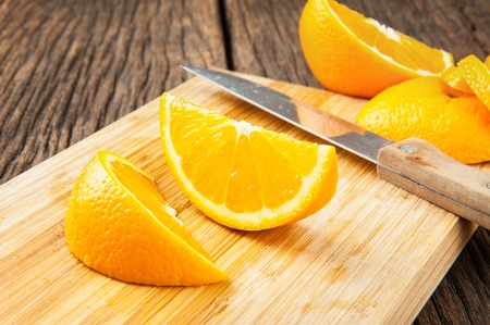 sliced ripe orange on wooden table