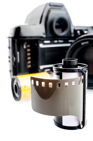 closeup camera film and black camera with opened back lid on white backgroundの写真素材