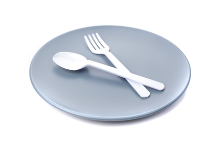 closeup plastic cutlery on plateの写真素材
