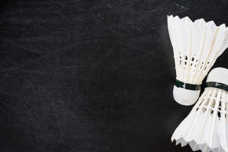 black board background with shuttlecocks