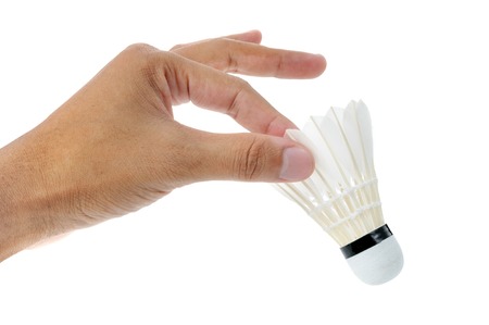 shuttlecock in human hand isolated on white backgroundの写真素材