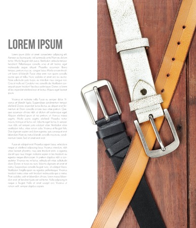 isolate leather belts on wooden plankの写真素材