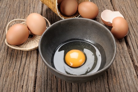 closeup group of fresh eggs on wooden plank