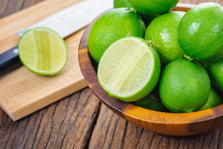 fresh green limes on wooden desk