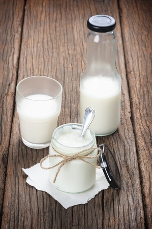 fresh natural yogurt in glass on wooden plankの写真素材