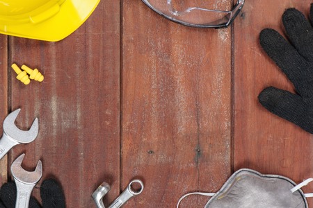 personal safety equipments on wooden plank with space in the centerの写真素材