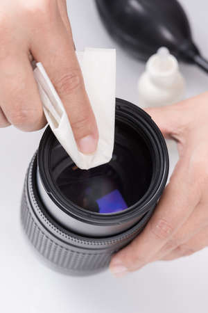 closeup the hand cleaning dirty lensの写真素材